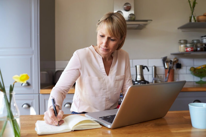 Woman on laptop in kitchen